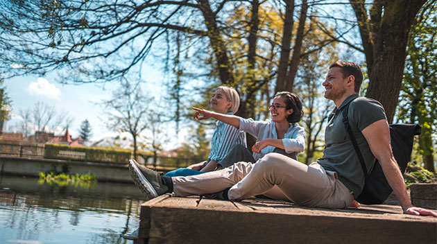 Friends sitting by a lake